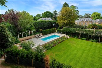 Surrey garden with raised terrace and contemporary pergola.