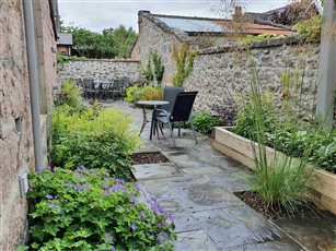 Courtyard garden.  Changing the paving layout to slow down movement through the space and create space for plants has transformed this once unloved courtyard.