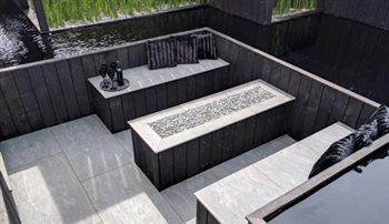 Southport Flower Show large gold medal winning garden: 'Kuro'.  Detail of the firepit and seating area.