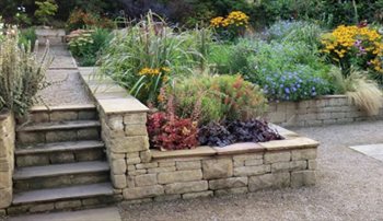 Terraced garden with dressed stone walls to give two distinctive tiers. Water feature, parterre, armillary and oriental area with tea house.