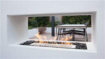 North London tropical entertaining space.  Bioethanol fireplace and dining area.