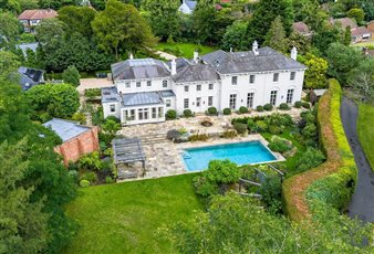 Grand house in Surrey with multiple terraces, oak pergola and pool.